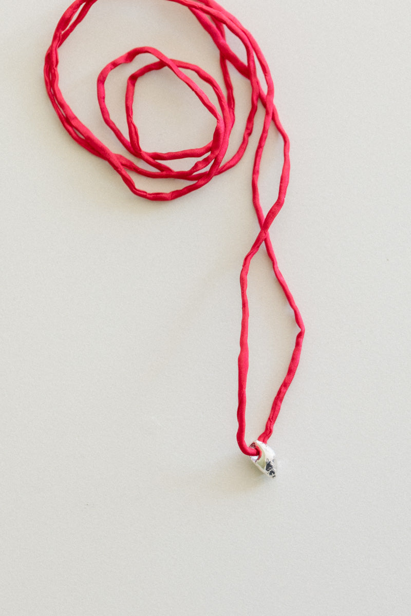 NO. 20 VENUS PEARL WITH A RED SILK CORD