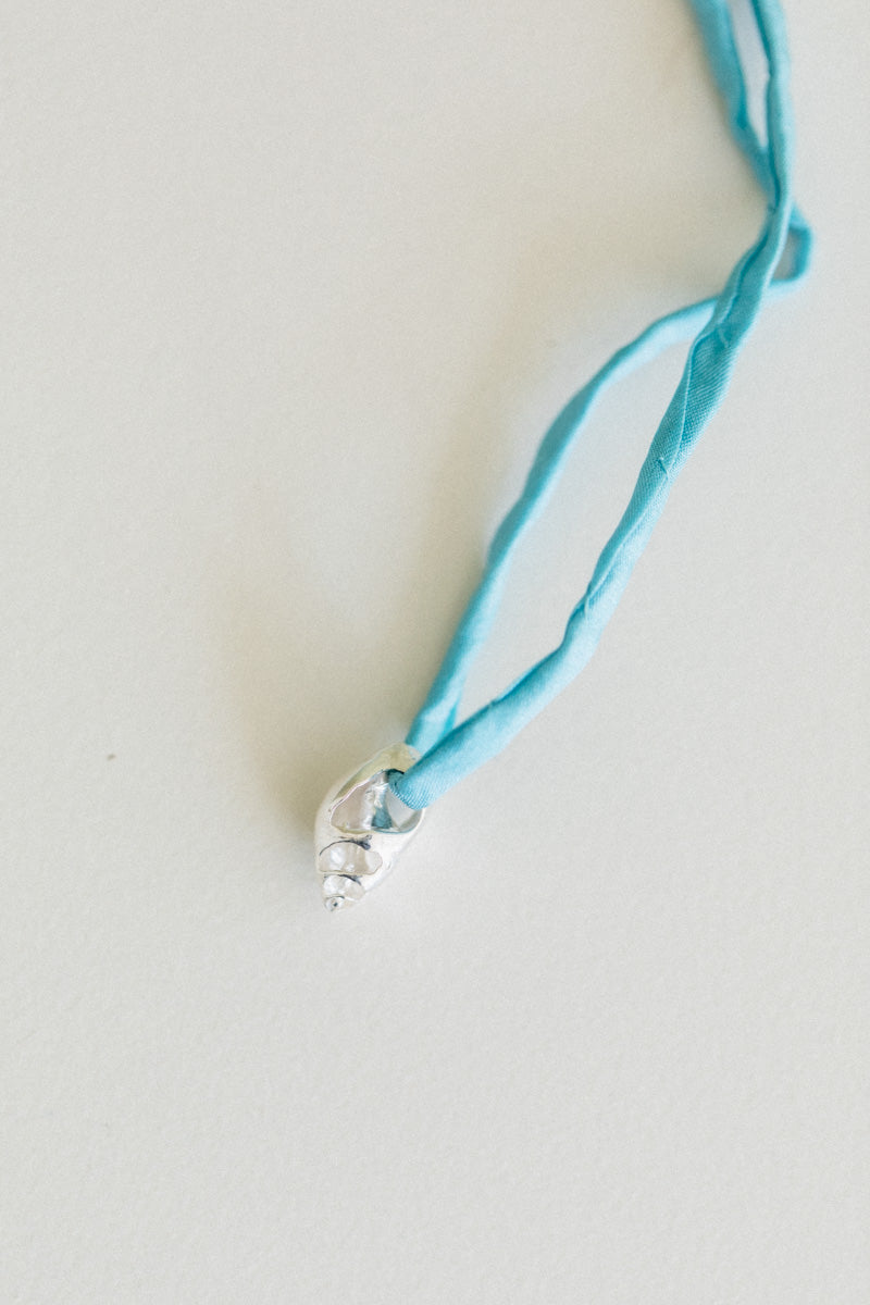 NO. 20 VENUS PEARL WITH A BLUE SILK CORD