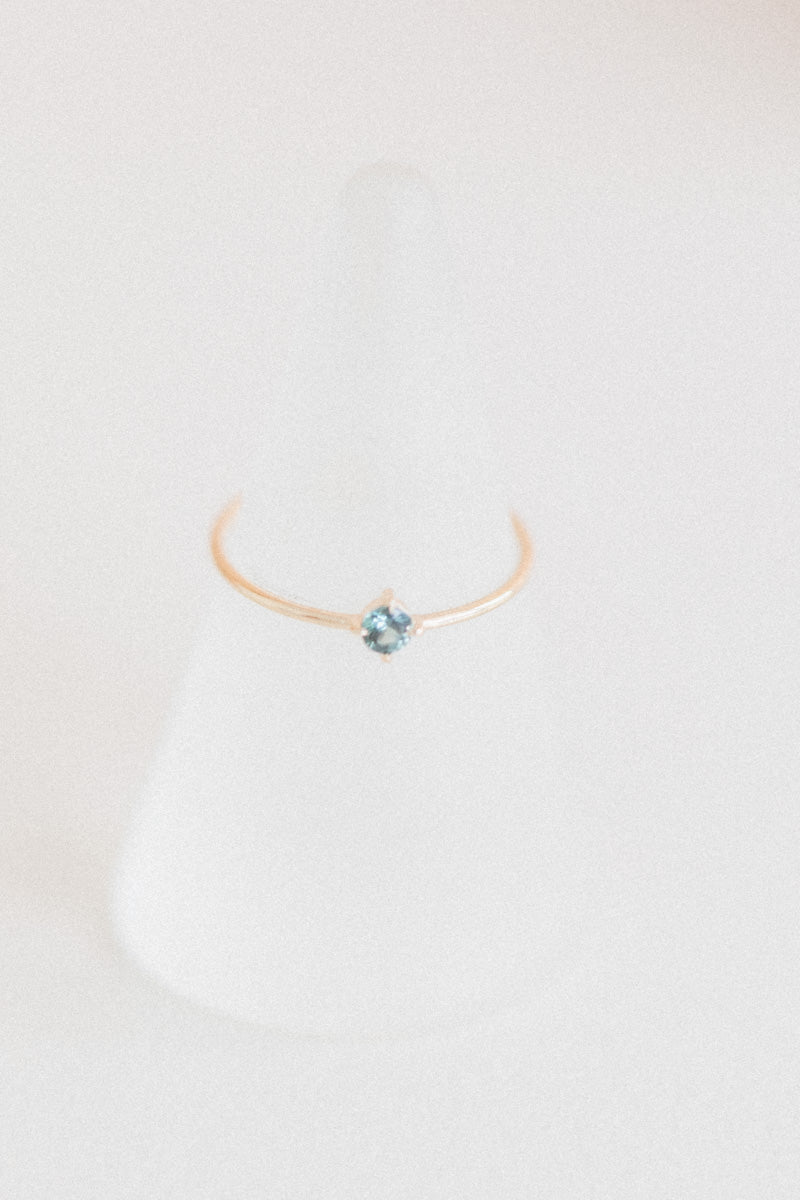 LITTLE SPARK RING WITH A ROUND TEAL SAPPHIRE