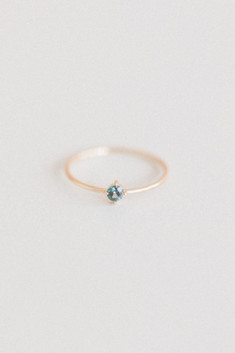 LITTLE SPARK RING WITH A ROUND TEAL SAPPHIRE