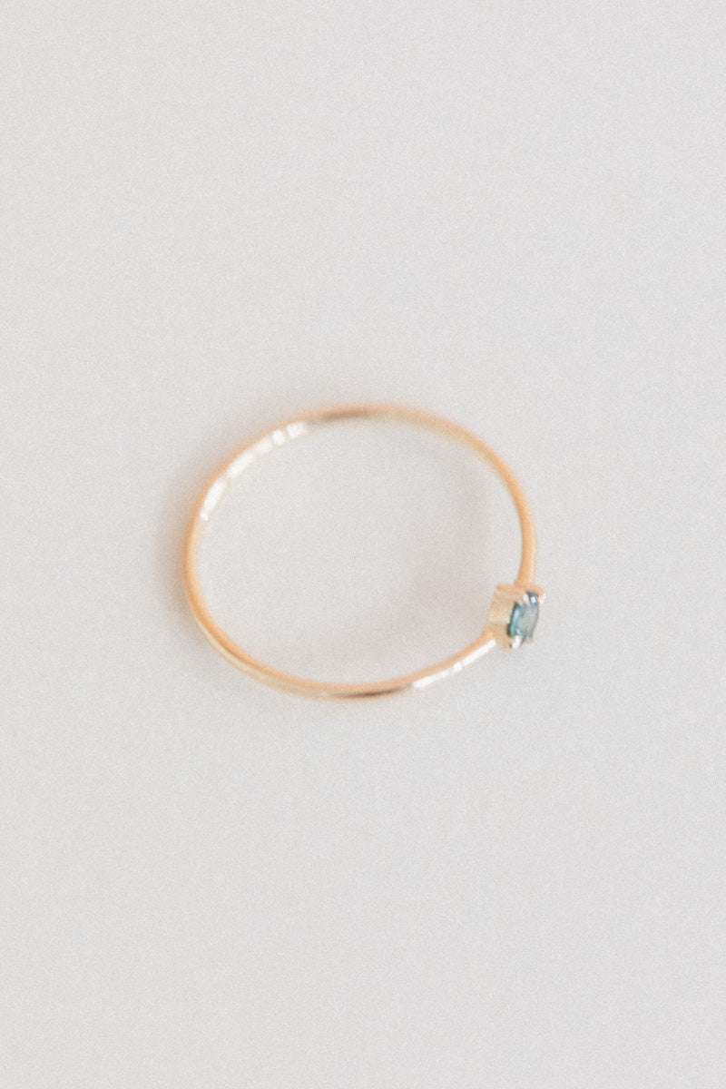 LITTLE SPARK RING WITH A ROUND TEAL SAPPHIRE