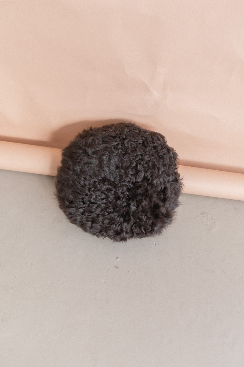 ROUND SHEARLING PILLOW IN LICORICE